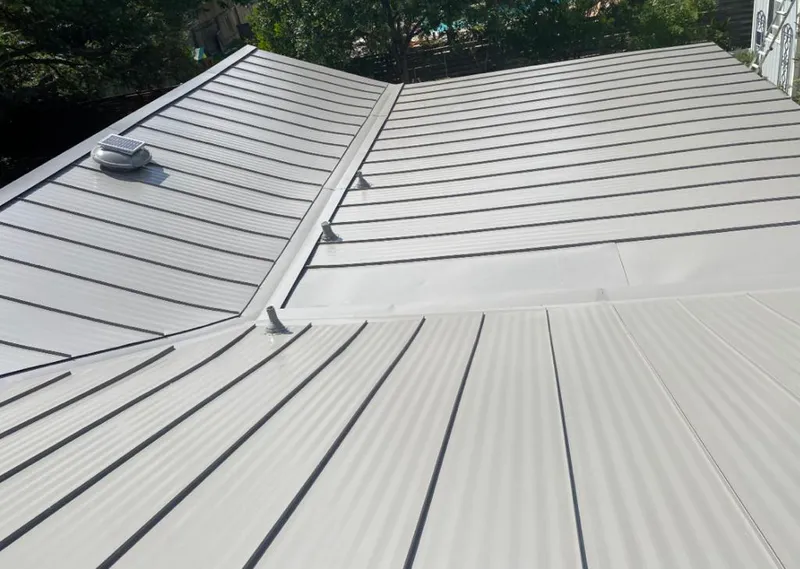 Solar attic fan installed on a metal roof for Roof Ventilation in Chickasaw